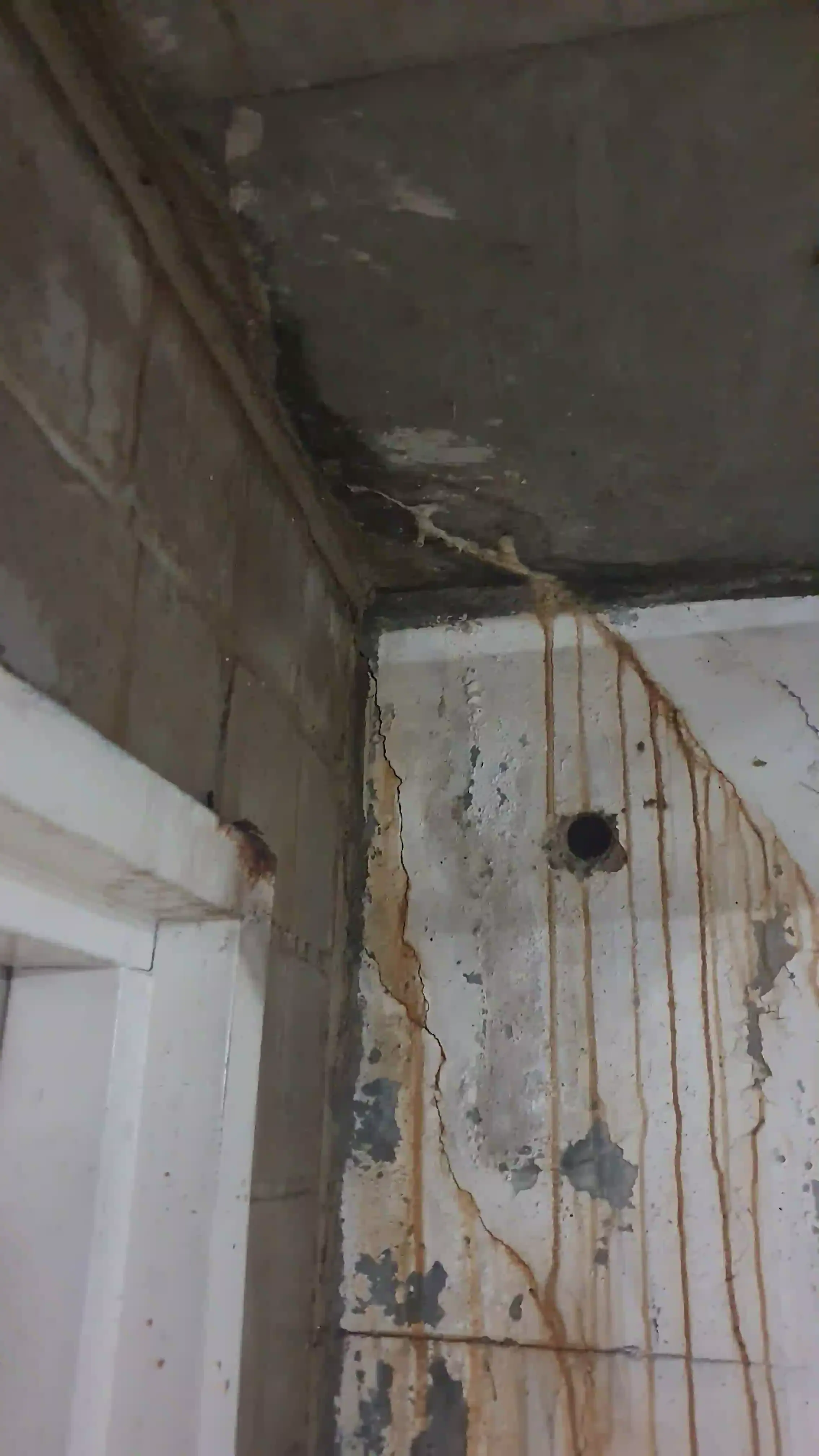 SP52948-rusting-door-frame-and-wall-damages-near-Block-C-fire-door-due-to-concrete-slab-water-leaks-photo-7-1Mar2022.webp