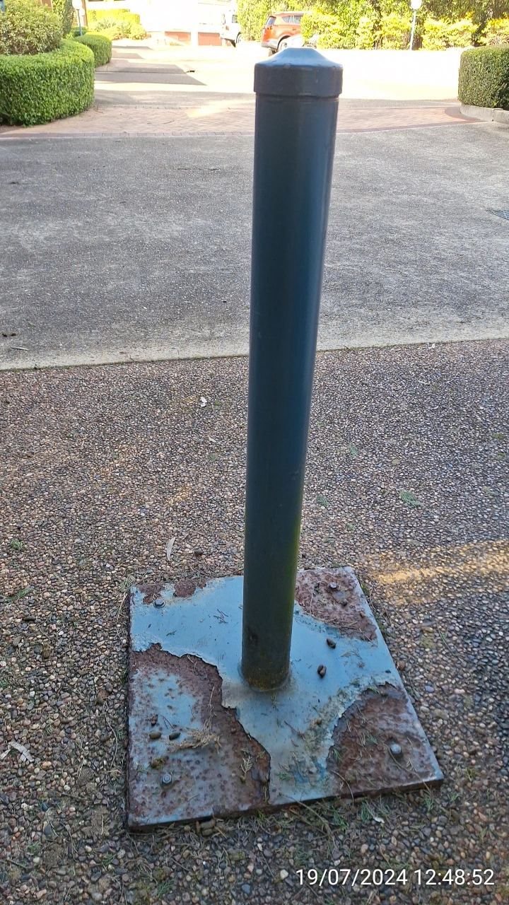 SP52948-rusted-bollard-near-townhouses-19Jul2024